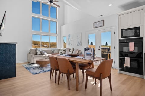 Enjoy the two story open-concept living area adjacent to the dining area and kitchen.  The upper level deck, complete with grill, is accessible via French doors.