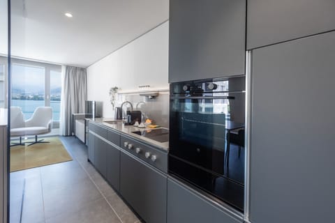 Junior Suite, Lake View | Private kitchen | Full-size fridge, oven, stovetop, dishwasher