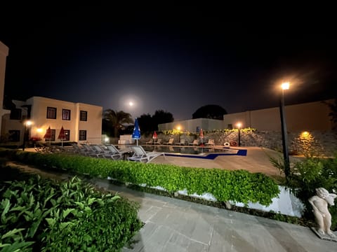 Seasonal outdoor pool, open 8:00 AM to 8:00 PM, pool umbrellas