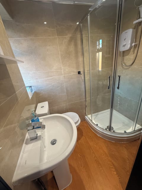 Shower, hair dryer, slippers, towels