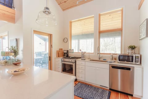 Kitchen area with views of screened porch and backyard