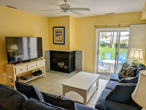 4 Lagoona Drive, Sea Pines, Bethany Beach-Living Area - Living room featuring a corner fireplace, white media console, and dark blue sofas.