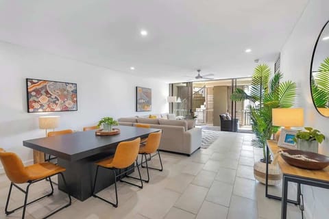 Dine together on the stylish wooden six-seater table with tan leather chairs. 
