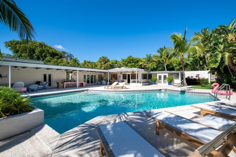 Palm Beach inspired designer home has a large pool and an expansive private lawn with mature landscaping and plenty of space. Enjoy the luxurious sitting areas around the pool, and experience outdoor living at its finest.