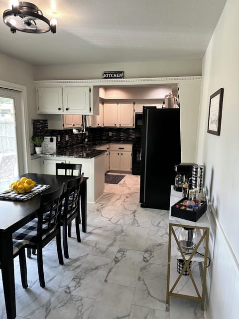 Dining room with ceiling fan, 6 seater dining table with access to backyard.