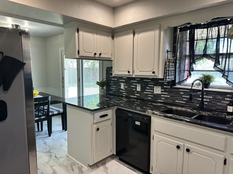 Soap, trash bags, dishwasher pods and fire extinguisher under sink.