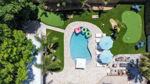 Your own private resort from above — a freeform pool, putting green, lush lawn, and lounge areas all in one stunning backyard made for making memories.