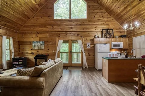 Living Room: Sunlit space with wooden charm and kitchen access, perfect for gathering and fun!