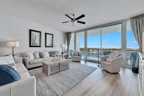 Spacious and inviting living area with floor-to-ceiling windows showcasing breathtaking panoramic views. This open-concept design seamlessly blends comfort and style, creating the perfect space for relaxation and entertainment.