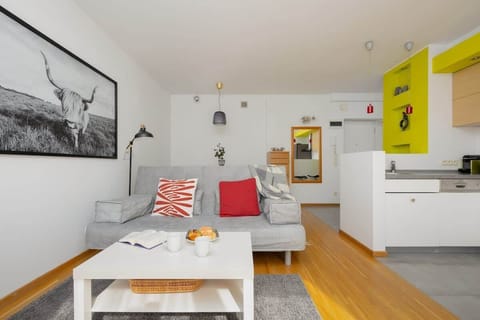 Relax in the stylish living room with a comfortable sofa and modern decor.