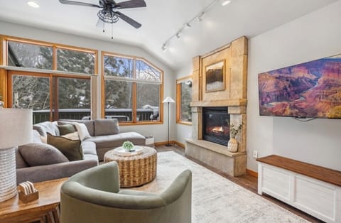 Main level living room with tv.   Deck access off of living room