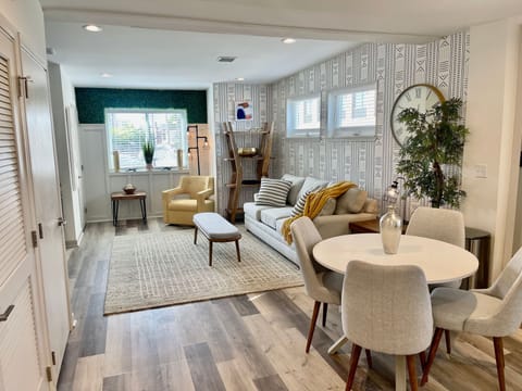 Living Room with sofa, sitting area, 65-inch Roku Smart TV & Dining Table