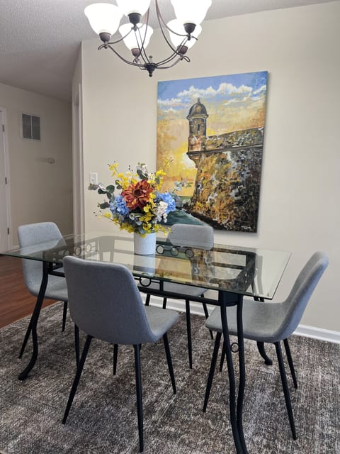 Dining table accommodates four guests. Toddler chair available & two bar stools.