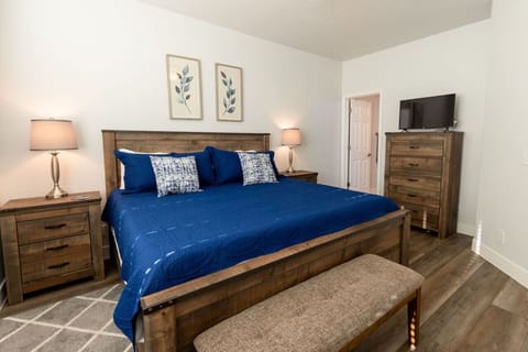 The primary bedroom is attached to a full bathroom.  It has plenty of clothes storage with dresser, end tables and closet. You can stream your favorite APPs while lounging in bed.
