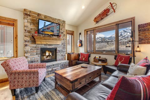 Curl up by the stone fireplace and admire stunning mountain views through expansive windows. Warm woods, plush seating, and inviting decor create your perfect alpine retreat.