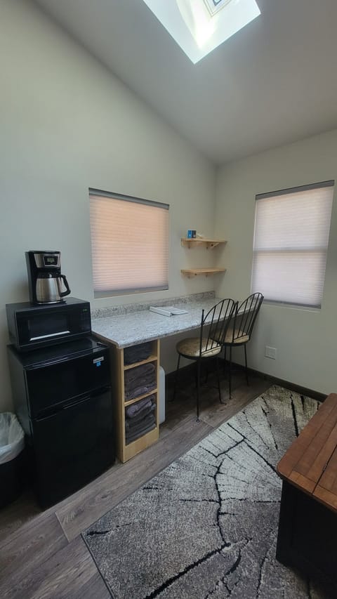 Counter top workspace, mini fridge, microwave and coffee pot.
