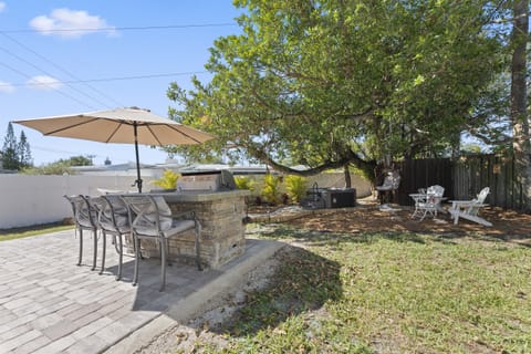 Backyard with outdoor kitchen/bar, hot tub, outdoor shower, hammock