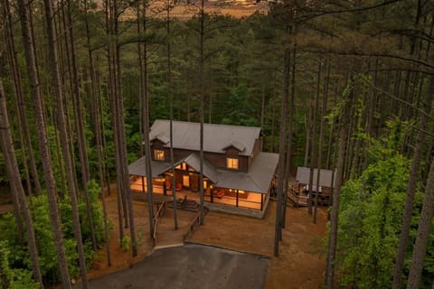 Aerial evening view of the cabin and driveway.