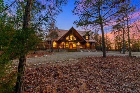 Wide Glide Lodge welcomes your group home as autumn dusk settles over the Hochatown woods — 1.3 private acres, four bedrooms, room to spread out.