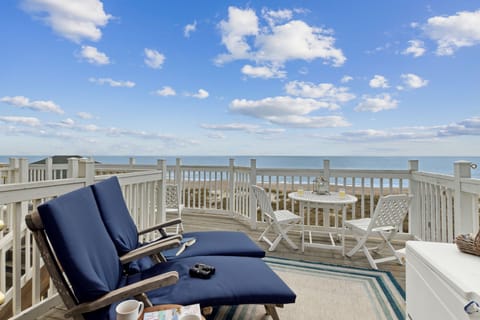 Third Floor Balcony with Dining Table and Lounge Chairs and Gorgeous Views of the Entire Shoreline