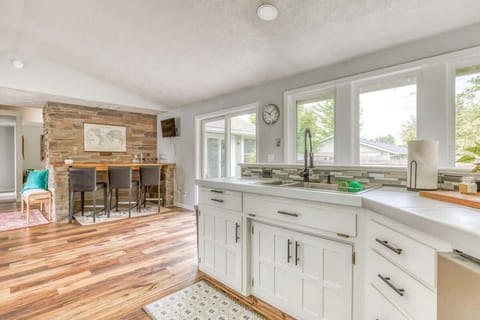 Gather around the kitchen counter for easy chats and snacks! Enjoy the open flow of your elevated vacation home.