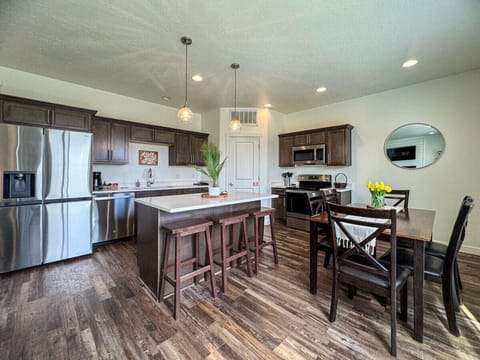 Bright open kitchen featuring island, bar seating, and adjacent dining space
