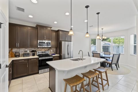 An open-concept kitchen and dining area with additional counter seating, creating a spacious and inviting space for cooking, dining, and entertaining.