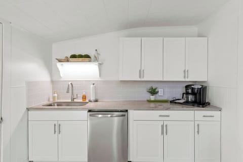 Kick-start your mornings in our chic, minimalist kitchen with a quick cup of coffee and serene decor accents.