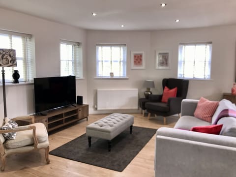 Large comfortable sofa and two armchairs with low lights. Smart 55” tv