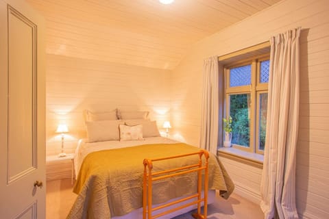 Sink into your cozy bedroom where warm lighting and those golden bedside lamps set the perfect mood for a peaceful getaway.