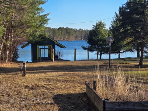 Backyard with lakefront view!  Boat house containing kayaks free for guest use. 