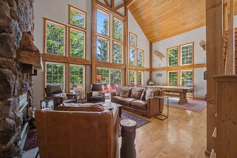 Relax in the spacious living room, bathed in natural light from the expansive windows, soak in nature and visit with friends and family.