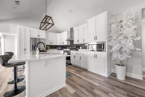 The industrial-chic kitchen amenities, like the stainless steel dishwasher and toaster, are just a reach away for ultimate convenience.