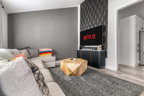 Sink into our massive, beige L-shaped sofa, complete with a shaggy grey rug that’s basically a hug for your feet. With "Netflix" already on the screen, the hardest decision you'll make is which episode to play next.