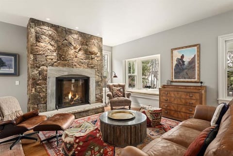 Open concept living room with large gas fireplace and plush furnishings