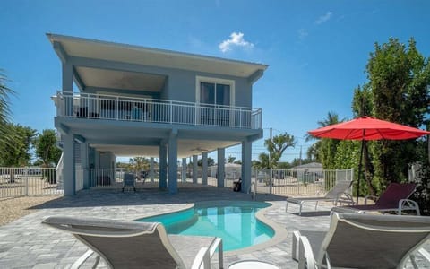 Stunning aerial view showcasing the home's canal-front location near the Florida Keys waterfront.