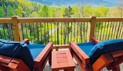 Relax on the furnished deck of A Tyme to Chill cabin in Wears Valley, Tennessee, and soak in breathtaking panoramic views of the Great Smoky Mountains.