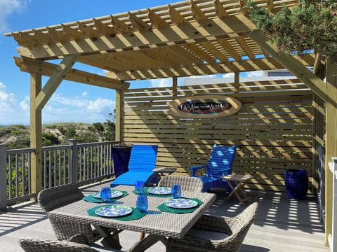 Oceanfront Gazebo with BBQ, lounge chairs and dining table.