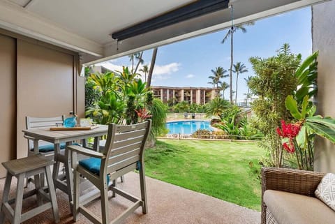 Enjoy your morning coffee or evening drinks on this cozy patio overlooking the lush garden and sparkling poo