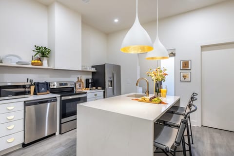 Kitchen features modern stainless-steel appliances.