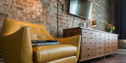 Leather armchair paired with a vintage chest of drawers for a retro vibe