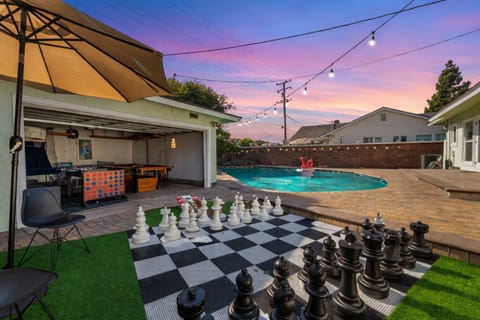 Large backyard with large chess game board, connect 4 and game room