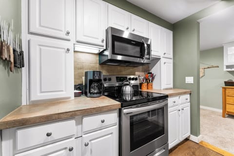 Full size kitchen featuring stainless steel appliances.