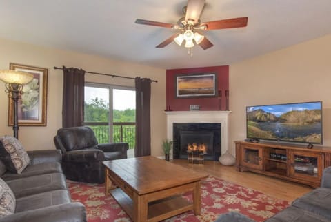 3 Bedroom Pigeon Forge Vacation Condo Rental on River near Dolly - Spacious Living Room with Gas Fireplace, Sleeper Sofa and SMART TV with Cable & WIFI throughout vacation rental