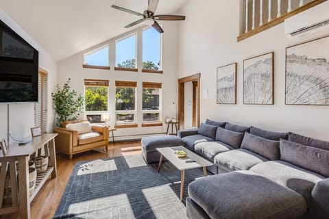 Living room with plenty of comfortable seating and 75` TV