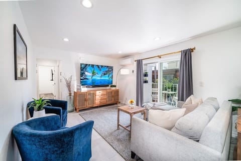 Condo's living room includes a 4K smart TV, pullout sofa bed, Xbox and PS4, and balcony.