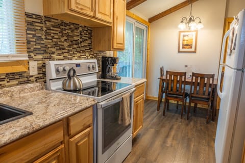 Upstairs kitchen and dining area with slider going to deck