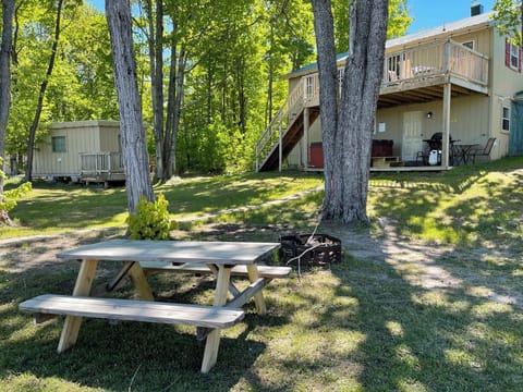 Fire pit area and backyard showing bunkhouse on the left