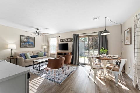 Light and bright living space with golf course views and walk out patio and sleeper sofa