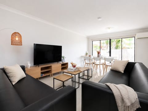 Living Area: Bright living space with comfortable seating and TV 